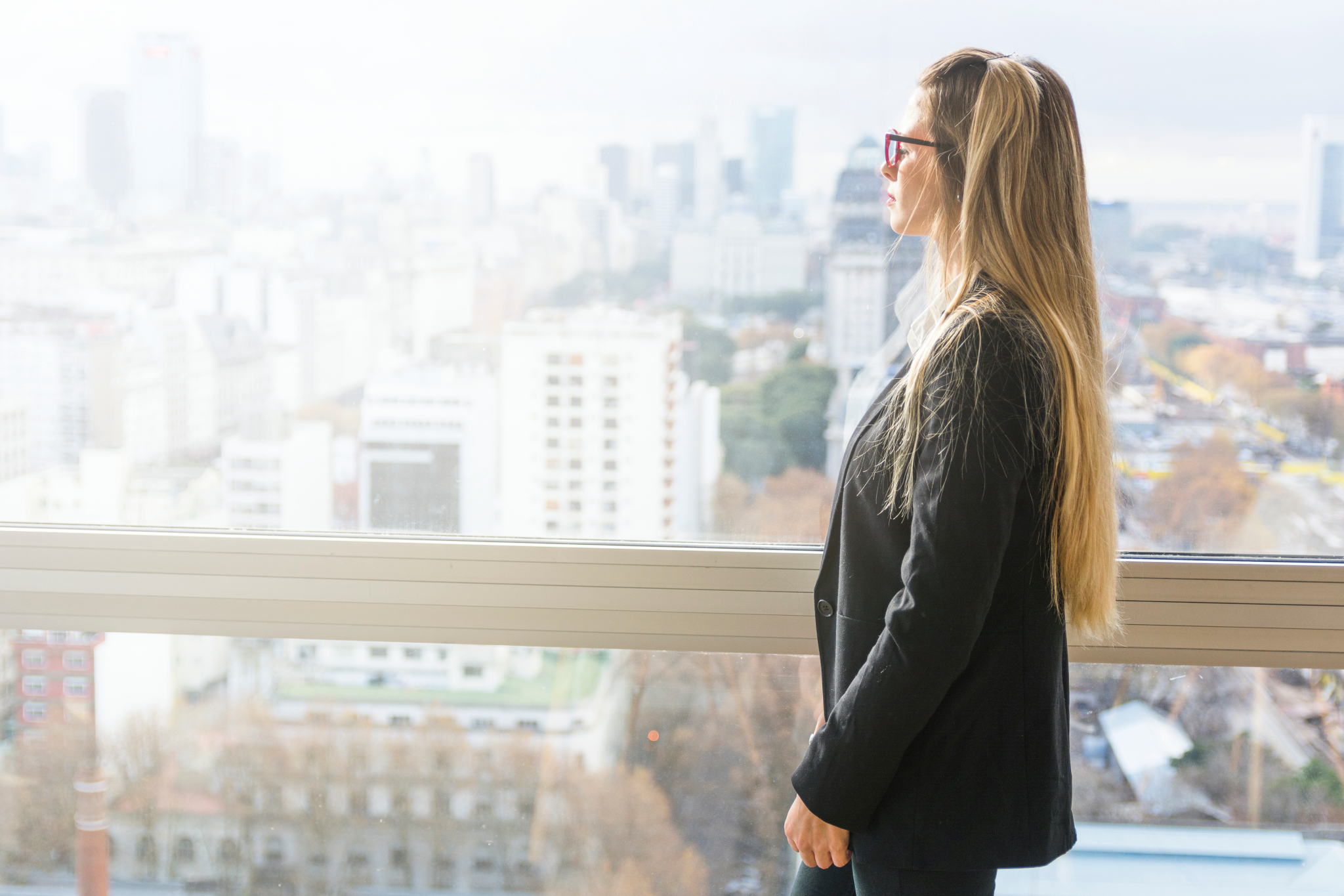 Woman looking out at city skyline.